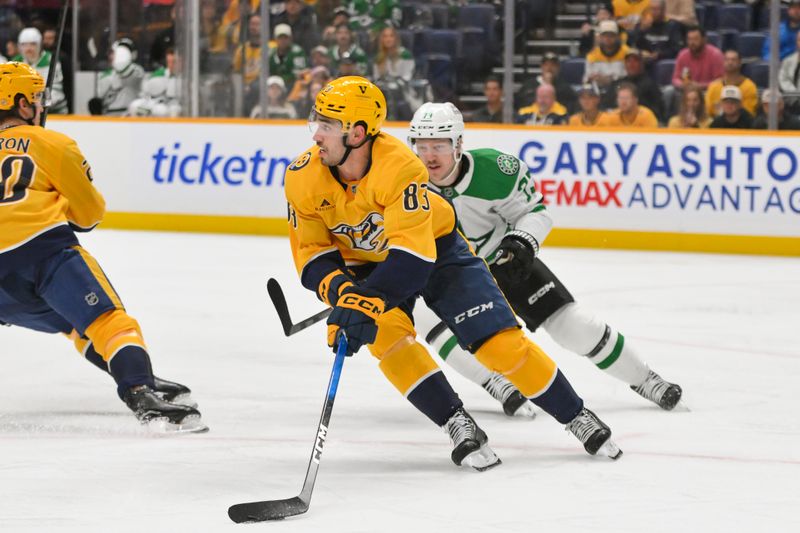 Oct 26, 2025; Nashville, Tennessee, USA;  Nashville Predators defenseman Adam Wilsby (83) skates with the puck as Dallas Stars left wing Adam Erne (73) chases during the second period at Bridgestone Arena. Mandatory Credit: Steve Roberts-Imagn Images