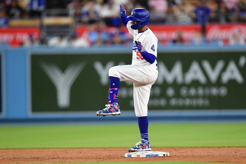 Apr 16, 2024; Los Angeles, California, USA; Los Angeles Dodgers shortstop Mookie Betts (50) reacts after reaching second on an RBI double against the Washington Nationals during the second inning at Dodger Stadium. Mandatory Credit: Gary A. Vasquez-USA TODAY Sports