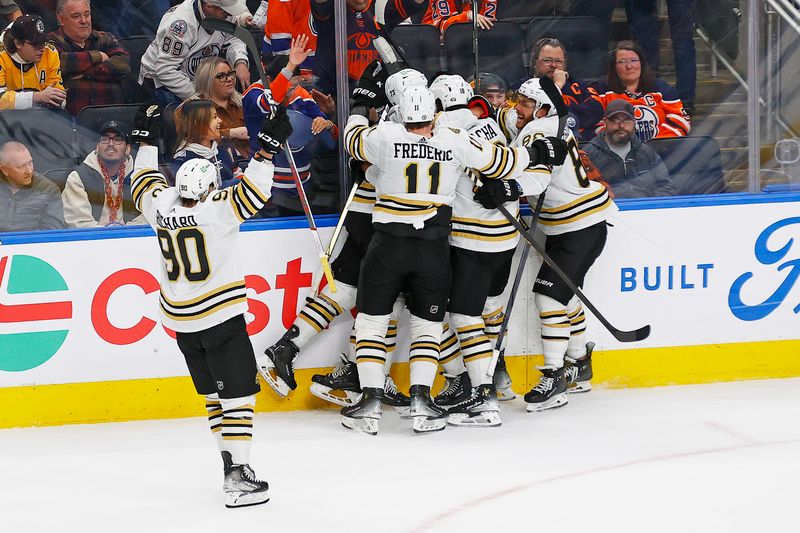 Feb 21, 2024; Edmonton, Alberta, CAN; The Boston Bruins celebrate an overtime winning goal by defensemen Charlie McAvoy (73) against the Edmonton Oilers at Rogers Place. Mandatory Credit: Perry Nelson-USA TODAY Sports