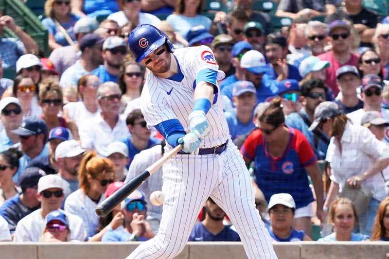 Jul 23, 2023; Chicago, Illinois, USA; Chicago Cubs left fielder Ian Happ (8) hits a single against the St. Louis Cardinals during the third inning at Wrigley Field. Mandatory Credit: David Banks-USA TODAY Sports