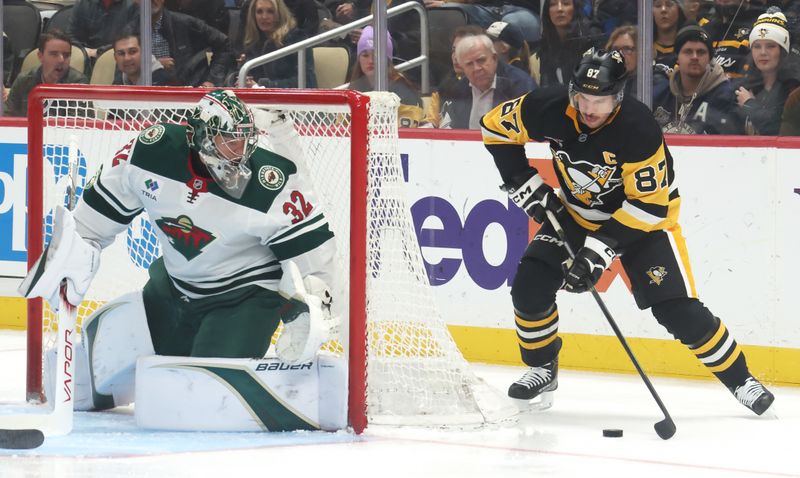 Nov 21, 2025; Pittsburgh, Pennsylvania, USA;  Minnesota Wild goaltender Filip Gustavsson (32) defends the net against Pittsburgh Penguins center Sidney Crosby (87) during the first period at PPG Paints Arena. Mandatory Credit: Charles LeClaire-Imagn Images