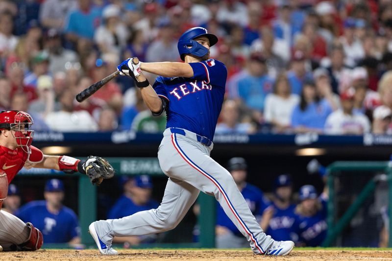 May 21, 2024; Philadelphia, Pennsylvania, USA; Texas Rangers shortstop Corey Seager (5) hits a home run during the eighth inning against the Philadelphia Phillies at Citizens Bank Park. Mandatory Credit: Bill Streicher-USA TODAY Sports