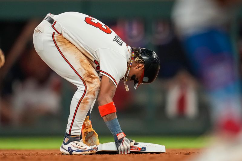 Sep 27, 2023; Cumberland, Georgia, USA; Atlanta Braves right fielder Ronald Acuna Jr. (13) reacts after stealing his 70th base of the season against the Chicago Cubs during the tenth inning at Truist Park. Mandatory Credit: Dale Zanine-USA TODAY Sports