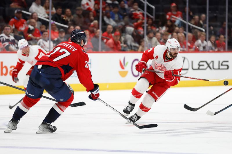 Sep 28, 2023; Washington, District of Columbia, USA; Detroit Red Wings center Robby Fabbri (14) flips the puck past Washington Capitals defenseman Alexander Alexeyev (27) in the third period at Capital One Arena. Mandatory Credit: Geoff Burke-USA TODAY Sports