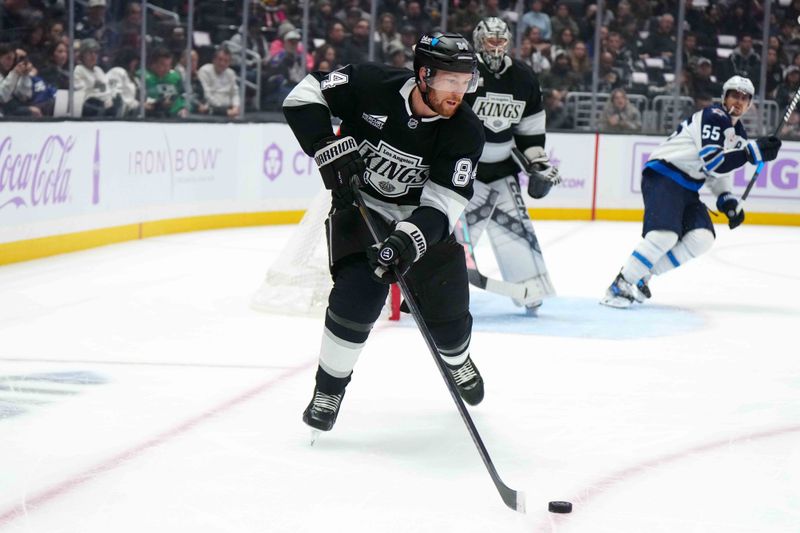 Nov 27, 2024; Los Angeles, California, USA; LA Kings defenseman Vladislav Gavrikov (84) skates with the puck against the Winnipeg Jets in the first period at Crypto.com Arena. Mandatory Credit: Kirby Lee-Imagn Images