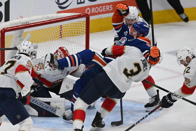 Jun 6, 2025; Edmonton, Alberta, CAN; Florida Panthers defenseman Seth Jones (3) checks Edmonton Oilers right wing Corey Perry (90) during the second period in game two of the 2025 Stanley Cup Final at Rogers Place. Mandatory Credit: Walter Tychnowicz-Imagn Images