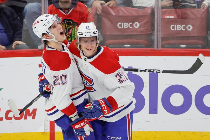 Dec 22, 2023; Chicago, Illinois, USA; Montreal Canadiens left wing Juraj Slafkovsky (20) celebrates with defenseman Kaiden Guhle (21) after scoring against the Chicago Blackhawks during the second period at United Center. Mandatory Credit: Kamil Krzaczynski-USA TODAY Sports