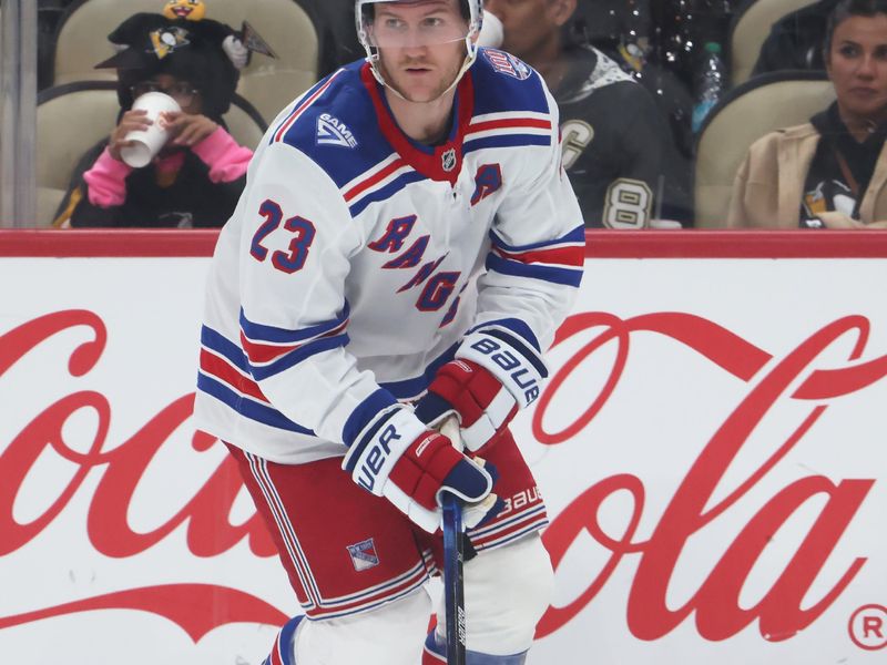 Oct 11, 2025; Pittsburgh, Pennsylvania, USA;  New York Rangers defenseman Adam Fox (23) handles the puck against the Pittsburgh Penguins during the third period at PPG Paints Arena. Mandatory Credit: Charles LeClaire-Imagn Images