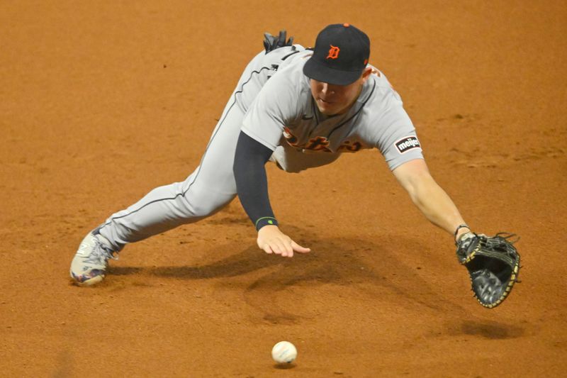 Aug 19, 2023; Cleveland, Ohio, USA; Detroit Tigers first baseman Spencer Torkelson (20) dives for the ball in the seventh inning against the Cleveland Guardians at Progressive Field. Mandatory Credit: David Richard-USA TODAY Sports