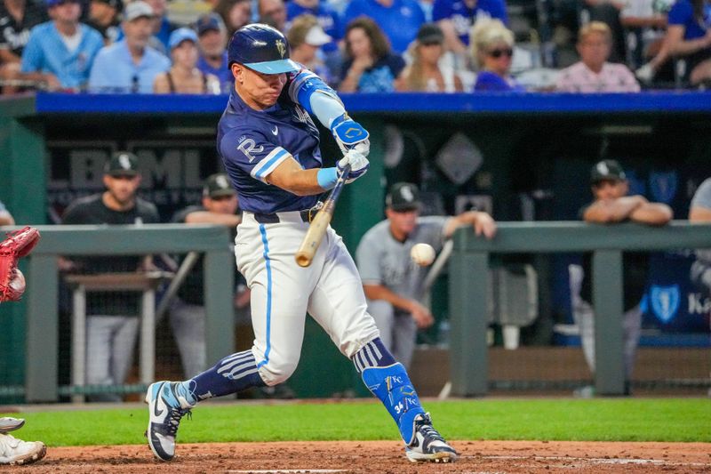 Jul 19, 2024; Kansas City, Missouri, USA; Kansas City Royals designated hitter Freddy Fermin (34) hits a one run single against the Chicago White Sox in the fifth inning at Kauffman Stadium. Mandatory Credit: Denny Medley-USA TODAY Sports