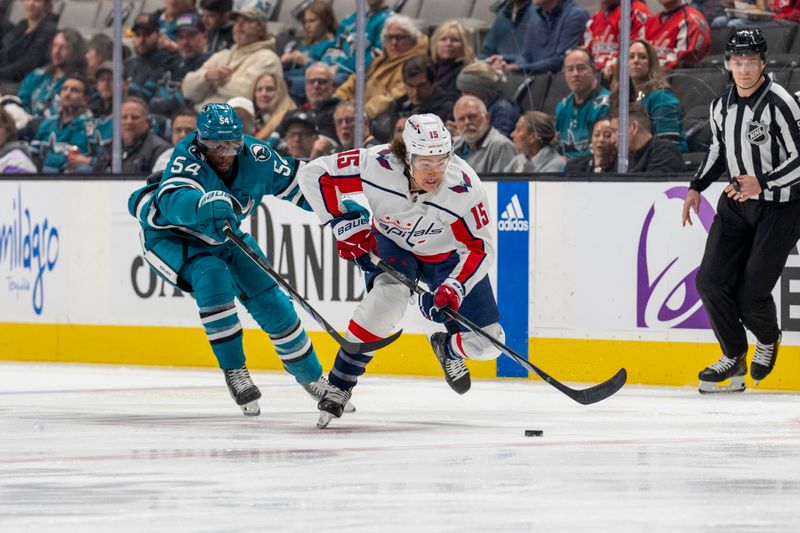 Nov 27, 2023; San Jose, California, USA; San Jose Sharks right wing Givani Smith (54) battles for the puck against Washington Capitals left wing Sonny Milano (15) during the first period at SAP Center at San Jose. Mandatory Credit: Neville E. Guard-USA TODAY Sports