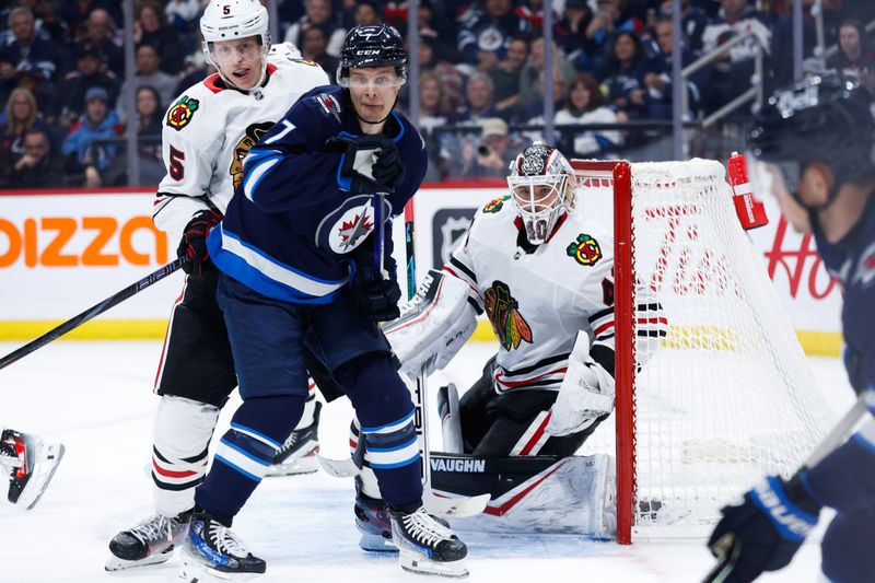 Oct 11, 2024; Winnipeg, Manitoba, CAN; Chicago Blackhawks defenseman Connor Murphy (5) jostles for position with Winnipeg Jets forward Vladislav Namestnikov (7) during the second period at Canada Life Centre. Mandatory Credit: Terrence Lee-Imagn Images