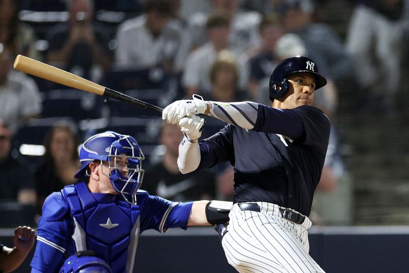 Mar 1, 2024; Tampa, Florida, USA;  New York Yankees right fielder Juan Soto (22) doubles against the Toronto Blue Jays in the first inning at George M. Steinbrenner Field. Mandatory Credit: Nathan Ray Seebeck-USA TODAY Sports