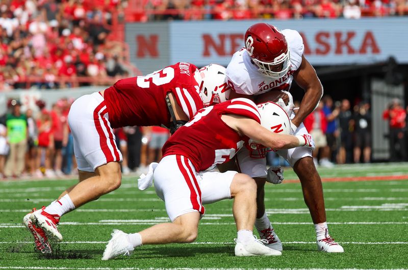 Sep 17, 2022; Lincoln, Nebraska, USA;  Nebraska Cornhuskers linebacker Isaac Gifford (23) and Nebraska Cornhuskers linebacker Nick Henrich (42) tackle Oklahoma Sooners tight end Brayden Willis (9) during the first half at Memorial Stadium. Mandatory Credit: Kevin Jairaj-USA TODAY Sports