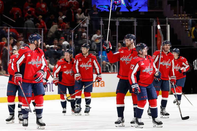 Feb 26, 2024; Washington, District of Columbia, USA; Washington Capitals players celebrate after their game against the Ottawa Senators at Capital One Arena. Mandatory Credit: Geoff Burke-USA TODAY Sports