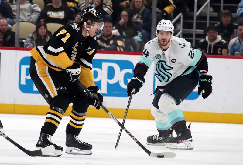 Jan 14, 2025; Pittsburgh, Pennsylvania, USA;  Pittsburgh Penguins center Evgeni Malkin (71) moves the puck against Seattle Kraken defenseman Jamie Oleksiak (24) during the second period at PPG Paints Arena. Mandatory Credit: Charles LeClaire-Imagn Images