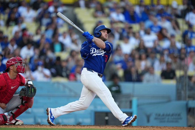 Mar 23, 2025; Los Angeles, California, USA; Los Angeles Dodgers third base Max Muncy (13) hits a home run in the fifth inning against the Los Angeles Angels  at Dodger Stadium. Mandatory Credit: Kirby Lee-Imagn Images