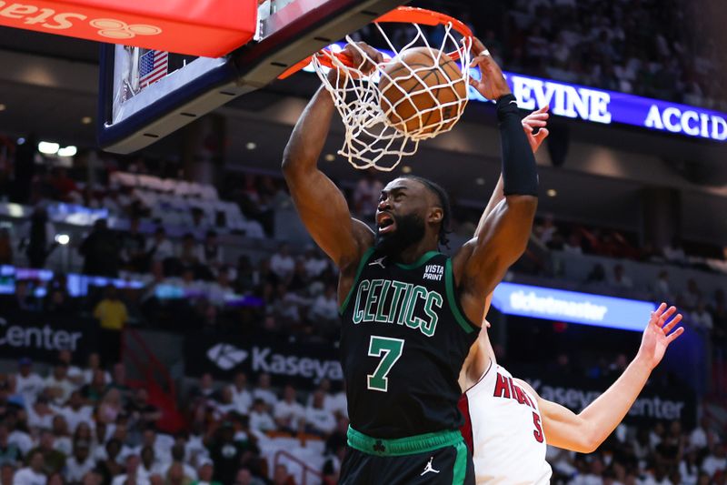 MIAMI, FLORIDA - APRIL 27: Jaylen Brown #7 of the Boston Celtics dunks the ball past Nikola Jovic #5 of the Miami Heat during the first quarter in game three of the Eastern Conference First Round Playoffs at Kaseya Center on April 27, 2024 in Miami, Florida.  NOTE TO USER: User expressly acknowledges and agrees that, by downloading and or using this photograph, User is consenting to the terms and conditions of the Getty Images License Agreement. (Photo by Megan Briggs/Getty Images)