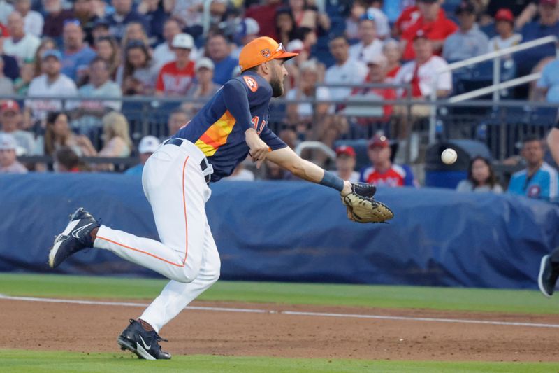 Mar 15, 2024; West Palm Beach, Florida, USA; Houston Astros first baseman David Hensley (11) fields a soft infield dribbler and attempts an unsuccessful glove toss to the bag during the fifth inning at The Ballpark of the Palm Beaches. Mandatory Credit: Reinhold Matay-USA TODAY Sports