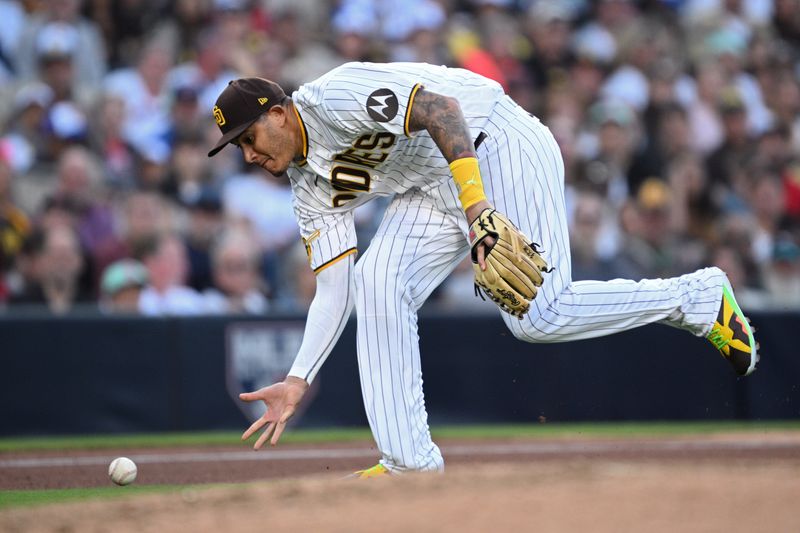 Jun 15, 2023; San Diego, California, USA; San Diego Padres third baseman Manny Machado (13) attempts to make a bare-handed play during the fourth inning against the Cleveland Guardians at Petco Park. Mandatory Credit: Orlando Ramirez-USA TODAY Sports