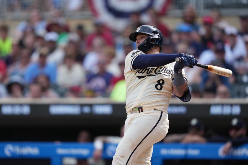 Aug 11, 2024; Minneapolis, Minnesota, USA; Minnesota Twins catcher Christian Vazquez (8) hits a single during the ninth inning against the Cleveland Guardians at Target Field. Mandatory Credit: Jordan Johnson-USA TODAY Sports