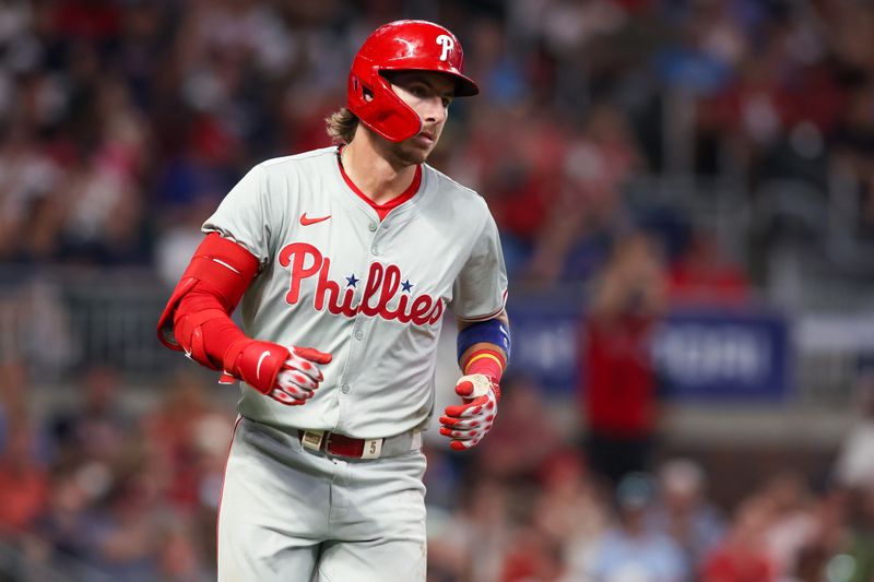 Jul 5, 2024; Atlanta, Georgia, USA; Philadelphia Phillies designated hitter Bryson Stott (5) hits a single against the Atlanta Braves in the seventh inning at Truist Park. Mandatory Credit: Brett Davis-USA TODAY Sports