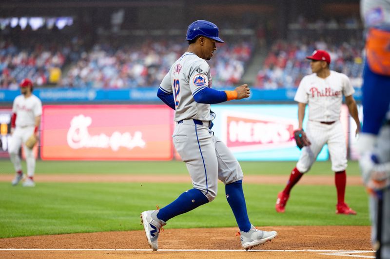 May 15, 2024; Philadelphia, Pennsylvania, USA; New York Mets shortstop Francisco Lindor (12) scores against the Philadelphia Phillies during the first inning at Citizens Bank Park. Mandatory Credit: Bill Streicher-USA TODAY Sports