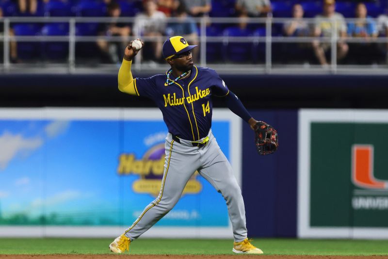 May 20, 2024; Miami, Florida, USA; Milwaukee Brewers second baseman Andruw Monasterio (14) throws to first base against the Miami Marlins during the fifth inning at loanDepot Park. Mandatory Credit: Sam Navarro-USA TODAY Sports