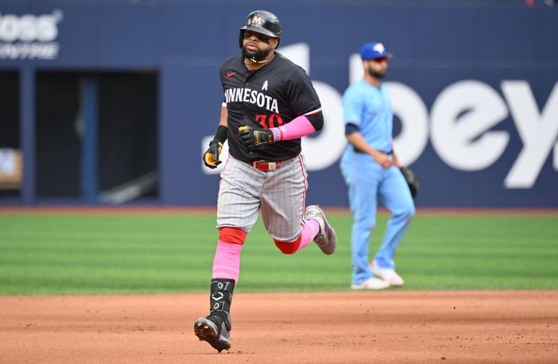 May 12, 2024; Toronto, Ontario, CAN;  Minnesota Twins first baseman Carlos Santana (30) rounds the bases after hitting a three run home run against the Toronto Blue Jays in the seventh inning at Rogers Centre. Mandatory Credit: Dan Hamilton-USA TODAY Sports