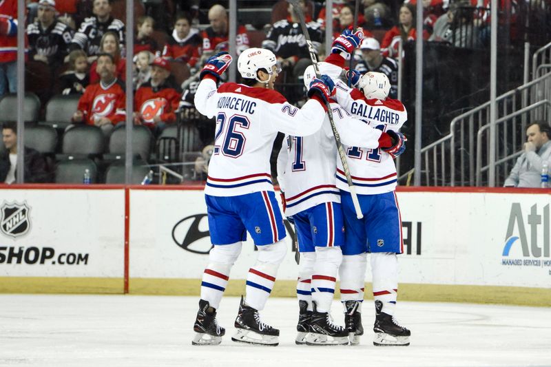 Feb 24, 2024; Newark, New Jersey, USA; Montreal Canadiens right wing Brendan Gallagher (11) celebrates with teammates after scoring a goal against the New Jersey Devils during the second period at Prudential Center. Mandatory Credit: John Jones-USA TODAY Sports