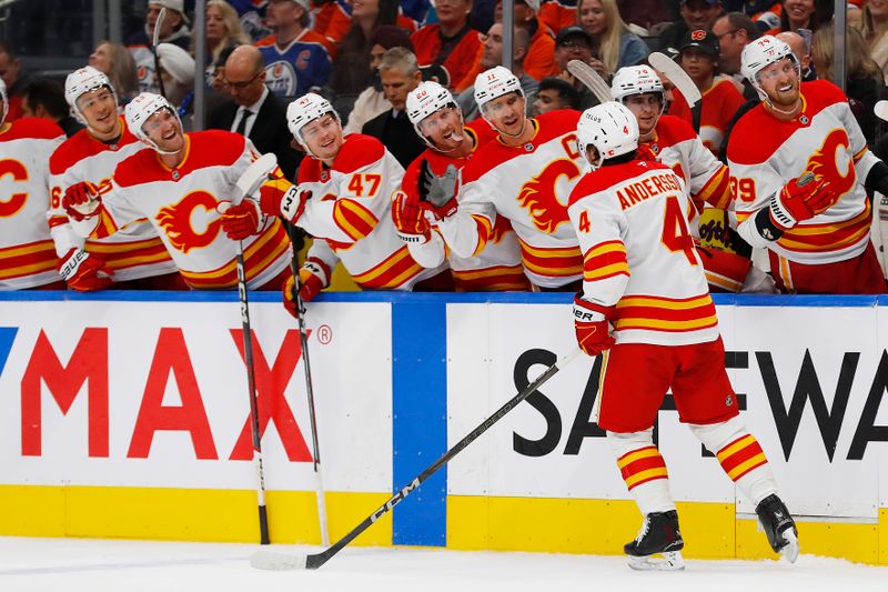 Oct 13, 2024; Edmonton, Alberta, CAN; The Calgary Flames celebrate a goal scored by defensemen Rasmus Andersson (4) during the second period against the Edmonton Oilers at Rogers Place. Mandatory Credit: Perry Nelson-Imagn Images