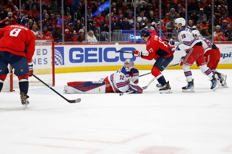 Jan 4, 2025; Washington, District of Columbia, USA; Washington Capitals center Dylan Strome (17) scores a goal on New York Rangers goaltender Jonathan Quick (32) in the first period at Capital One Arena. Mandatory Credit: Geoff Burke-Imagn Images