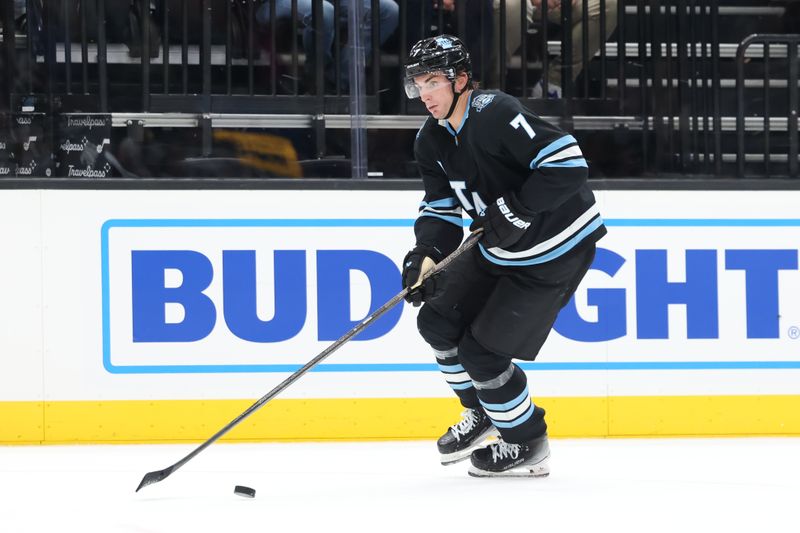 Oct 24, 2024; Salt Lake City, Utah, USA; Utah Hockey Club defenseman Michael Kesselring (7) brings the puck up the ice against the Colorado Avalanche during the third period at Delta Center. Mandatory Credit: Rob Gray-Imagn Images