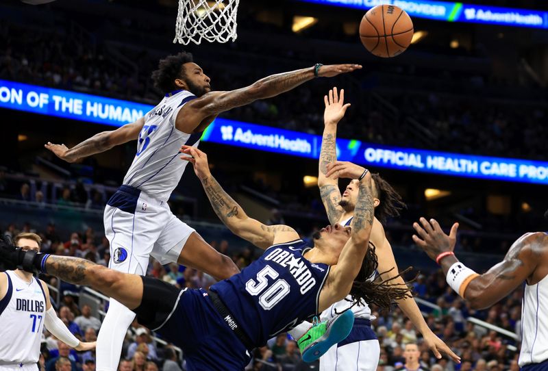 ORLANDO, FLORIDA - NOVEMBER 06: Cole Anthony #50 of the Orlando Magic tries to shoot over Derrick Jones Jr. #55 of the Dallas Mavericks during a game  at Amway Center on November 06, 2023 in Orlando, Florida. (Photo by Mike Ehrmann/Getty Images) NOTE TO USER: User expressly acknowledges and agrees that, by downloading and or using this photograph, User is consenting to the terms and conditions of the Getty Images License Agreement. (Photo by Mike Ehrmann/Getty Images)