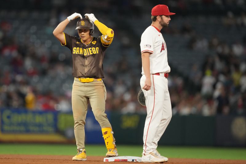 Jun 3, 2024; Anaheim, California, USA; San Diego Padres shortstop Ha-Seong Kim (7) gestures after hitting a double in the seventh inning as Los Angeles Angels second baseman Kyren Paris (19) watches at Angel Stadium. Mandatory Credit: Kirby Lee-USA TODAY Sports
