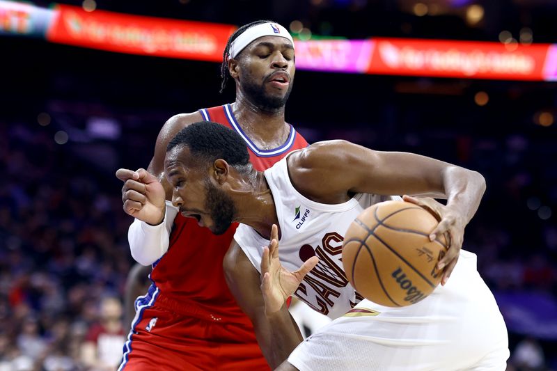 PHILADELPHIA, PENNSYLVANIA - FEBRUARY 23: Buddy Hield #17 of the Philadelphia 76ers guards as Evan Mobley #4 of the Cleveland Cavaliers drives to the basket during the third quarter at the Wells Fargo Center on February 23, 2024 in Philadelphia, Pennsylvania. (Photo by Tim Nwachukwu/Getty Images)