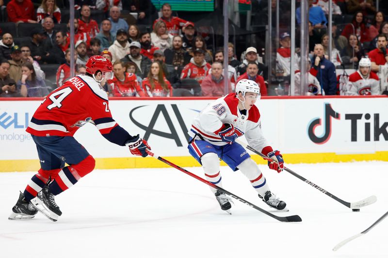 Jan 13, 2026; Washington, District of Columbia, USA; Montréal Canadiens defenseman Lane Hutson (48) skates with the puck as Washington Capitals center Connor McMichael (24) defends in overtime at Capital One Arena. Mandatory Credit: Geoff Burke-Imagn Images