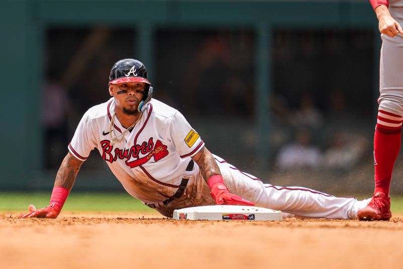 Aug 2, 2023; Cumberland, Georgia, USA; Atlanta Braves shortstop Orlando Arcia (11) slides into second base against the Los Angeles Angels during the fourth inning at Truist Park. Mandatory Credit: Dale Zanine-USA TODAY Sports