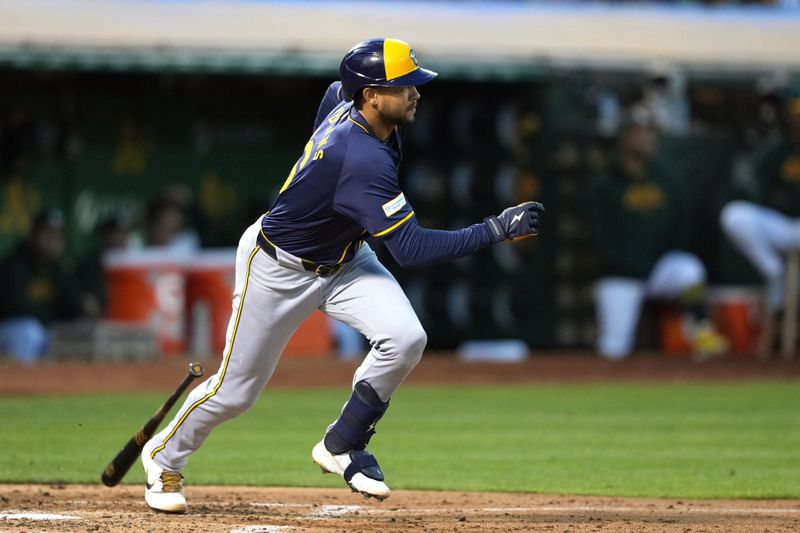 Aug 23, 2024; Oakland, California, USA; Milwaukee Brewers center fielder Blake Perkins (16) hits an RBI single against the Oakland Athletics during the fourth inning at Oakland-Alameda County Coliseum. Mandatory Credit: Darren Yamashita-USA TODAY Sports