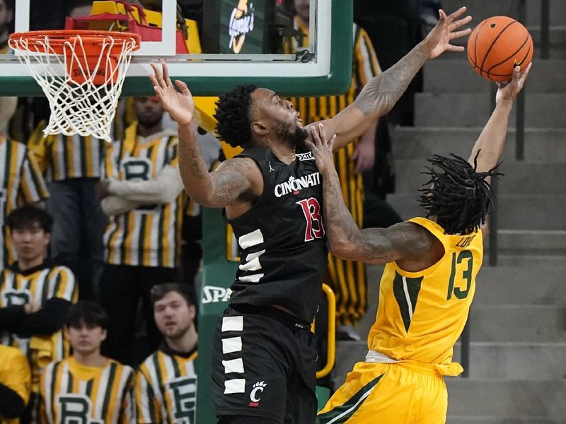 Jan 13, 2024; Waco, Texas, USA; Baylor Bears guard Langston Love (13) is defended  by Cincinnati Bearcats forward Jamille Reynolds (13) during the first half at Paul and Alejandra Foster Pavilion. Mandatory Credit: Raymond Carlin III-USA TODAY Sports