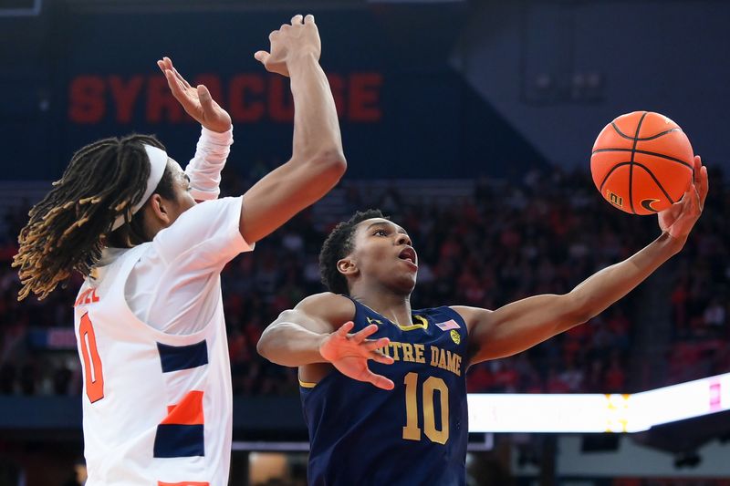 Jan 14, 2023; Syracuse, New York, USA; Notre Dame Fighting Irish guard Marcus Hammond (10) shoots the ball against the defense of Syracuse Orange forward Chris Bell (0) during the second half at the JMA Wireless Dome. Mandatory Credit: Rich Barnes-USA TODAY Sports