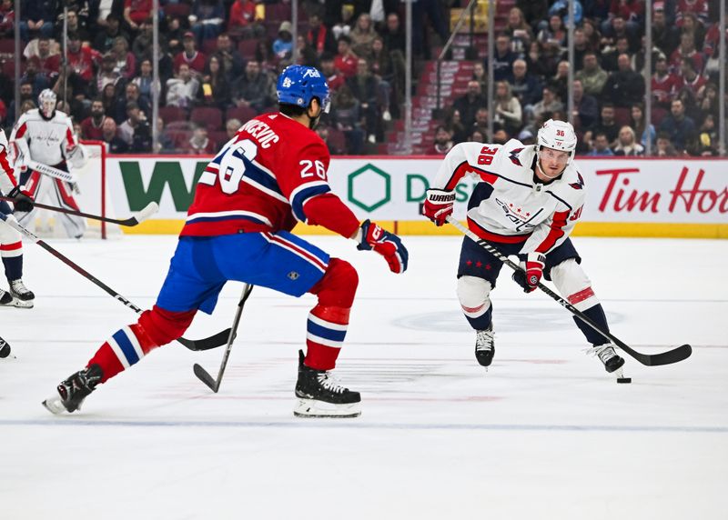 Oct 21, 2023; Montreal, Quebec, CAN; Washington Capitals defenseman Rasmus Sandin (38) plays the puck against Montreal Canadiens defenseman Johnathan Kovacevic (26) during the first period at Bell Centre. Mandatory Credit: David Kirouac-USA TODAY Sports