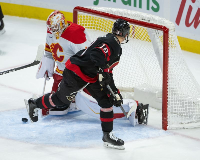 Oct 30, 2025; Ottawa, Ontario, CAN; Calgary Flames goalie Devin Cooley (1) makes a save in front of Ottawa Senators center Tim Stutzle (18) in the third period at the Canadian Tire Centre. Mandatory Credit: Marc DesRosiers-IMAGN Images