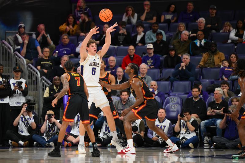 Mar 4, 2026; Seattle, Washington, USA; Washington Huskies forward Hannes Steinbach (6) passes the ball over Southern California Trojans forward Ezra Ausar (2) during the second half at Alaska Airlines Arena at Hec Edmundson Pavilion. Mandatory Credit: Steven Bisig-Imagn Images