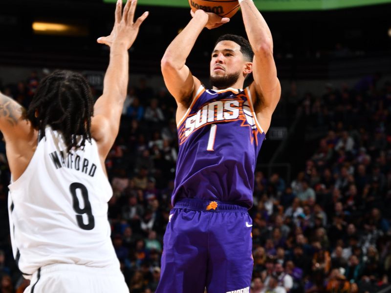 PHOENIX, AZ - NOVEMBER 27: Devin Booker #1 of the Phoenix Suns shoots a three point basket during the game against the Brooklyn Nets on November 27, 2024 at Footprint Center in Phoenix, Arizona. NOTE TO USER: User expressly acknowledges and agrees that, by downloading and or using this photograph, user is consenting to the terms and conditions of the Getty Images License Agreement. Mandatory Copyright Notice: Copyright 2024 NBAE (Photo by Barry Gossage/NBAE via Getty Images)