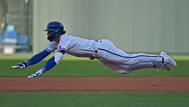 Jun 11, 2024; Kansas City, Missouri, USA; Kansas City Royals shortstop Bobby Witt Jr. (7) dives into second base for a double against the New York Yankees in the first inning at Kauffman Stadium. Mandatory Credit: Peter Aiken-USA TODAY Sports