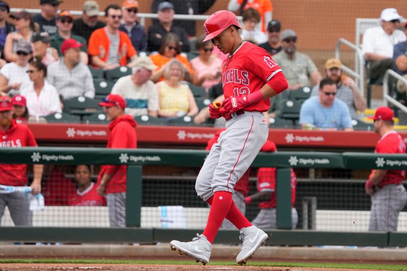 Feb 26, 2024; Scottsdale, Arizona, USA; Los Angeles Angels shortstop Ehire Adrianza (13) crosses the plate after hitting a solo home run against the San Francisco Giants in the first inning at Scottsdale Stadium. Mandatory Credit: Rick Scuteri-USA TODAY Sports