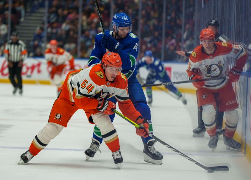 Jan 29, 2026; Vancouver, British Columbia, CAN;  Anaheim Ducks Center Mikael Granlund (64) pushes past Vancouver Canucks left wing Jake DeBrusk (74) in the second period at Rogers Arena. Mandatory Credit: Christopher Morris-Imagn Images