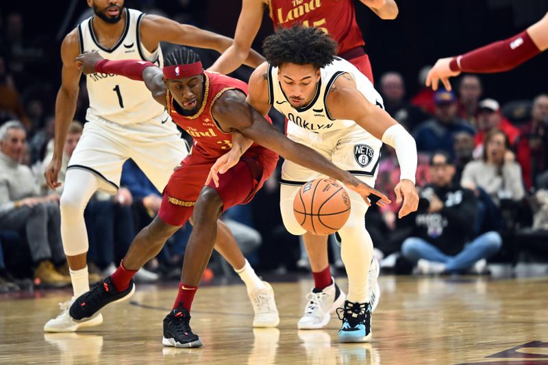 CLEVELAND, OHIO - MARCH 10: Caris LeVert #3 of the Cleveland Cavaliers and Jalen Wilson #22 of the Brooklyn Nets lunge for a loose ball during the second quarter at Rocket Mortgage Fieldhouse on March 10, 2024 in Cleveland, Ohio. NOTE TO USER: User expressly acknowledges and agrees that, by downloading and or using this photograph, User is consenting to the terms and conditions of the Getty Images License Agreement. (Photo by Jason Miller/Getty Images)