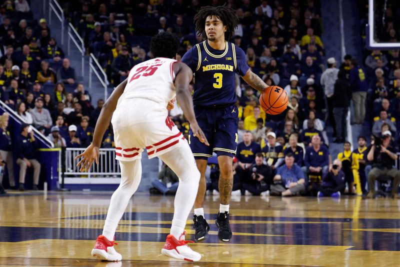 Jan 10, 2026; Ann Arbor, Michigan, USA;  Michigan Wolverines guard Elliot Cadeau (3) dribbles defended by Wisconsin Badgers guard John Blackwell (25) in the first half at Crisler Center. Mandatory Credit: Rick Osentoski-Imagn Images